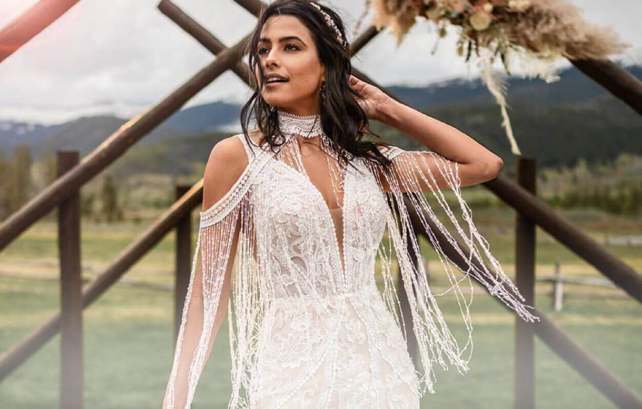 Model wearing a white boho bridal gown
