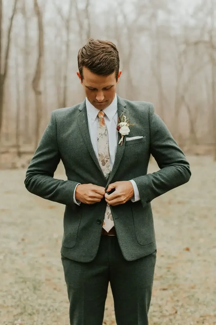 image shows a man wearing a green tuxedo