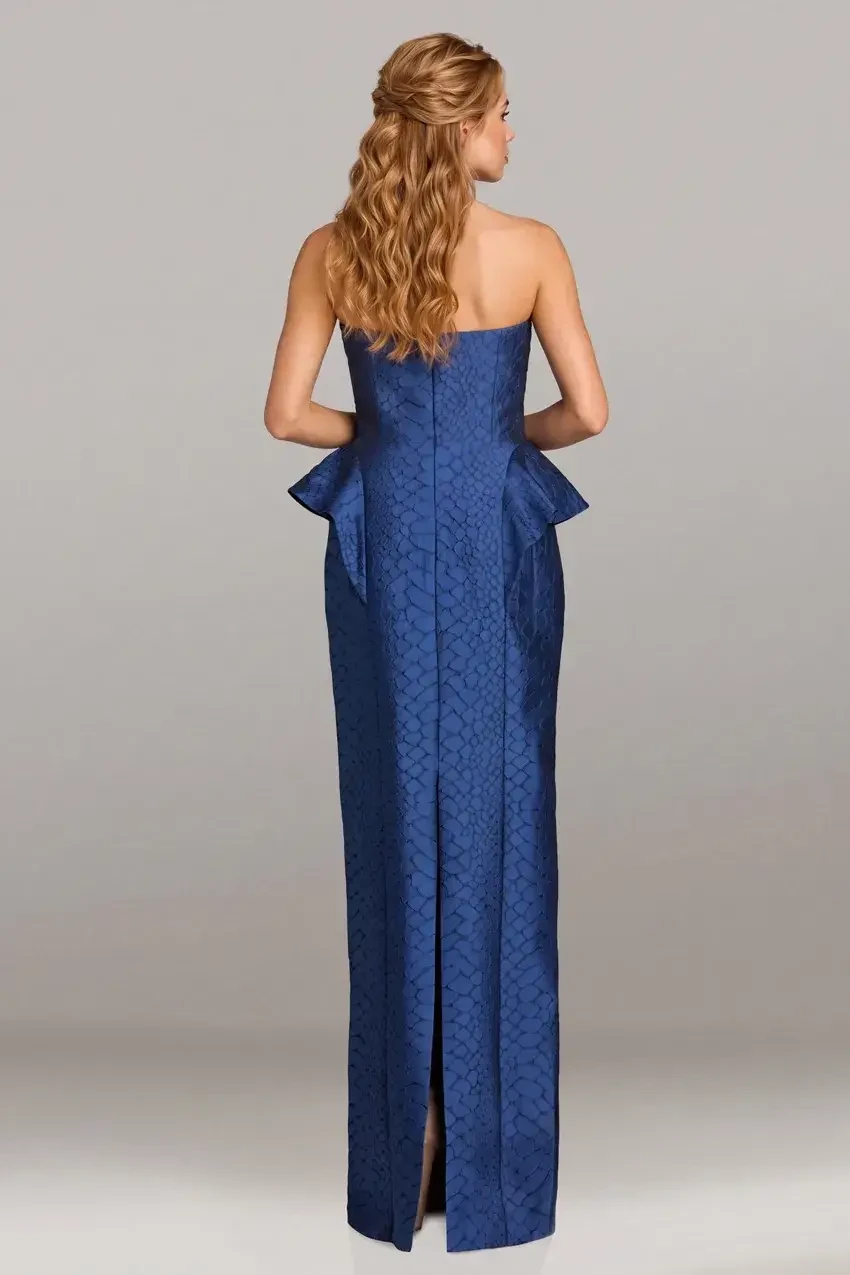 A woman in a strapless blue gown with a peplum detail.