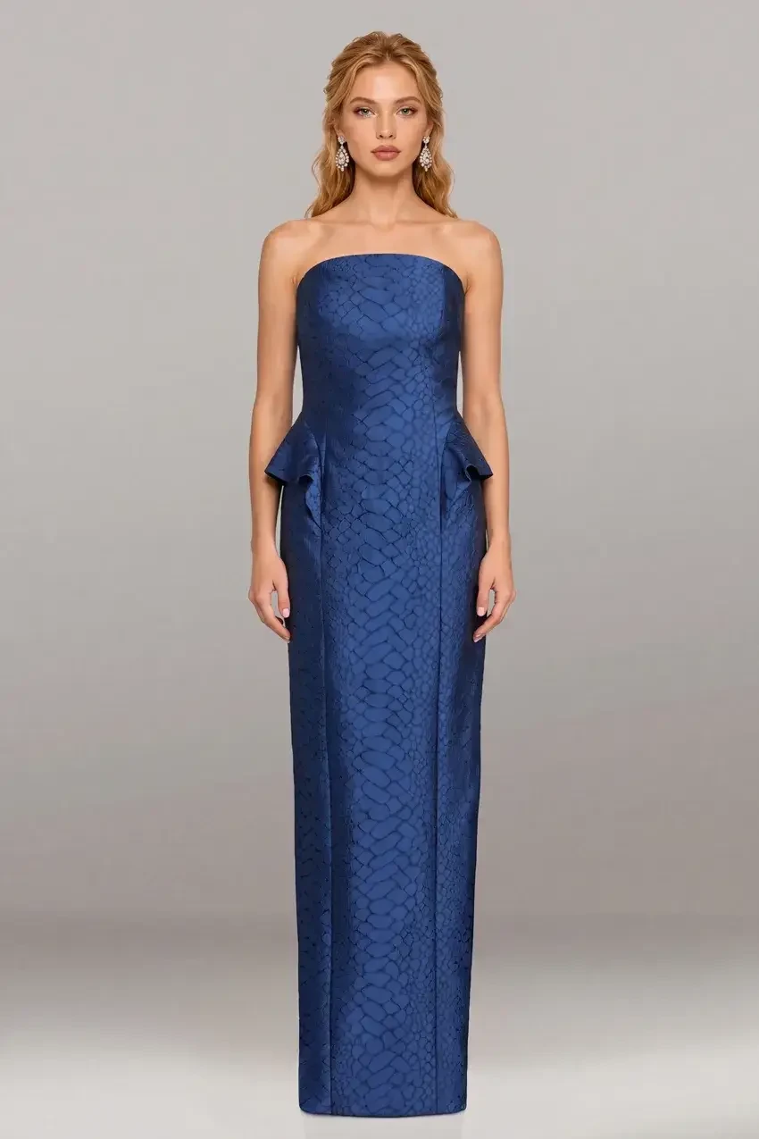 A woman in a strapless blue gown with a peplum detail.