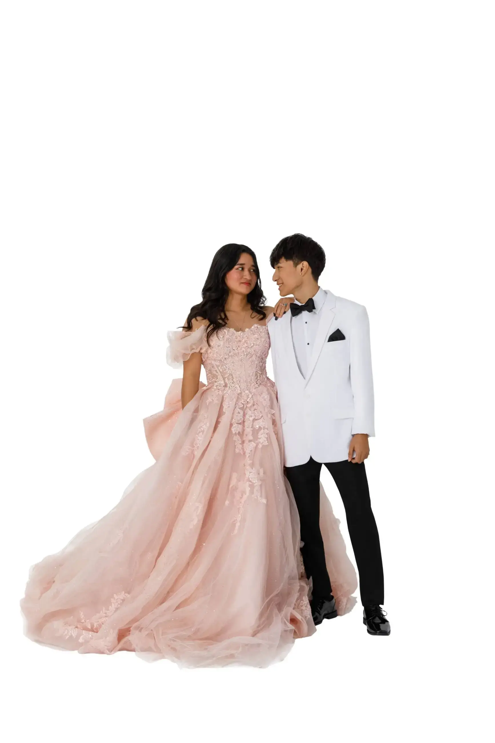 A couple in formal attire: a woman wearing a pink gown and a man in a white tuxedo, standing close together.
