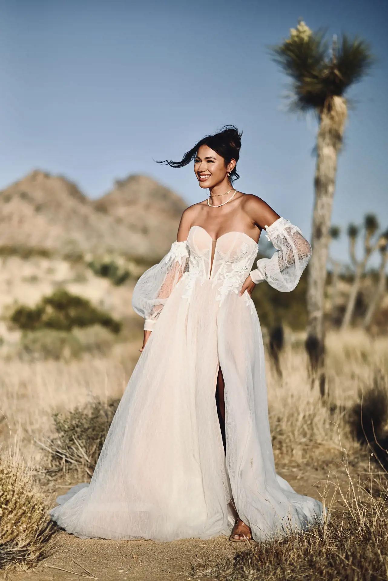 Model wearing a white boho bridal gown