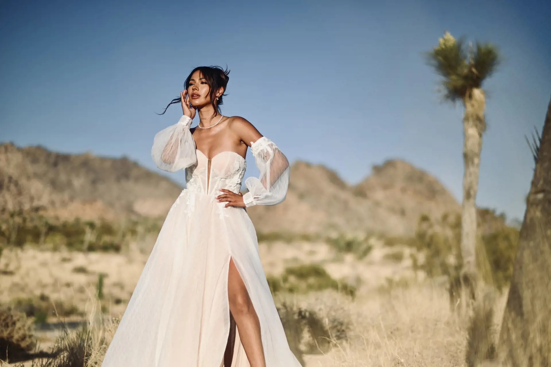 Model wearing a white boho bridal gown