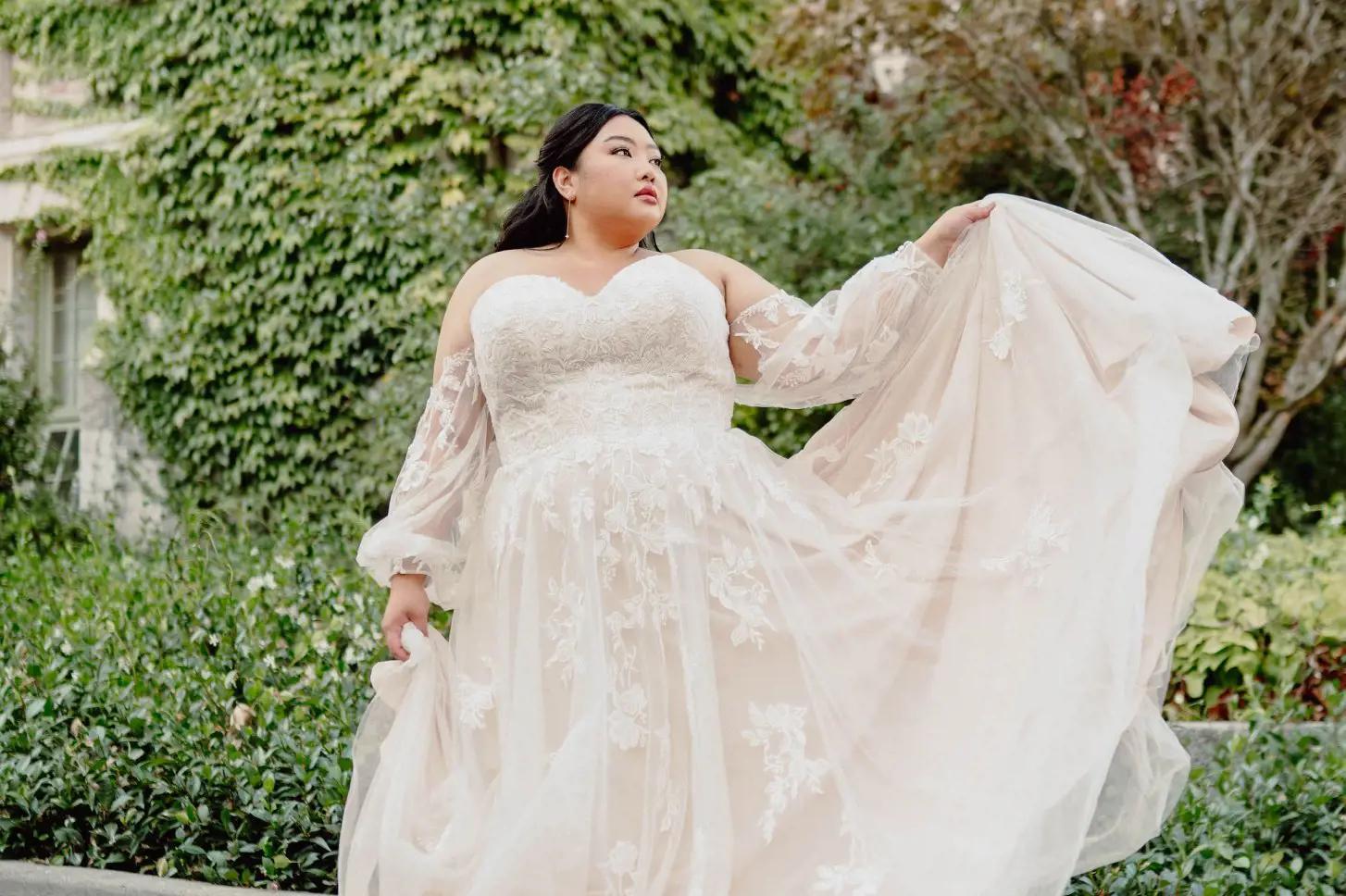 Plus size model wearing a white bridal gown