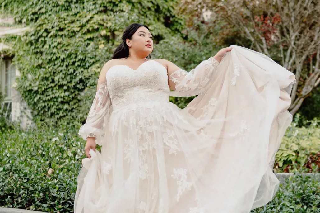 Plus size model wearing a white bridal gown