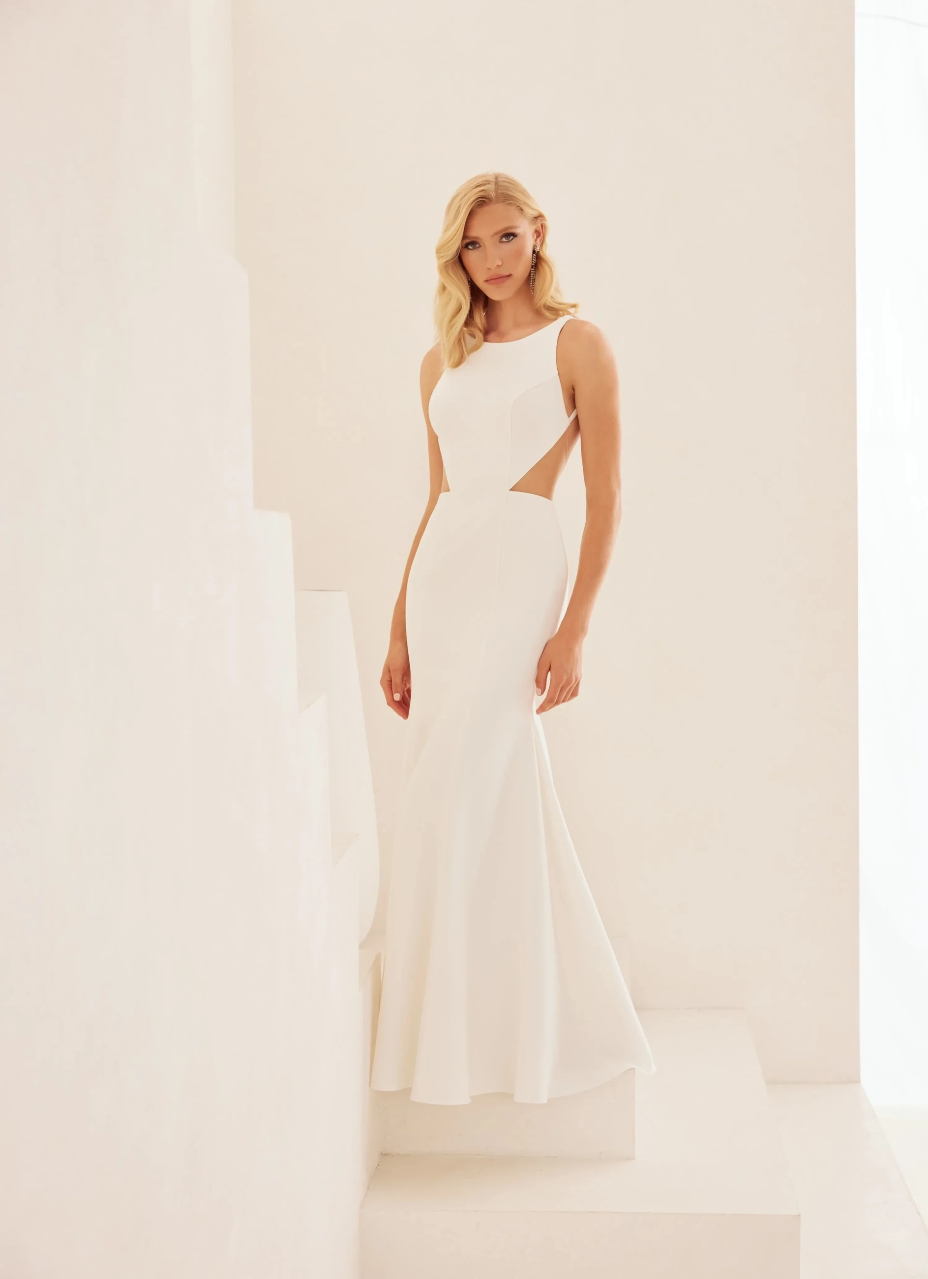 Model wearing a white simple bridal gown