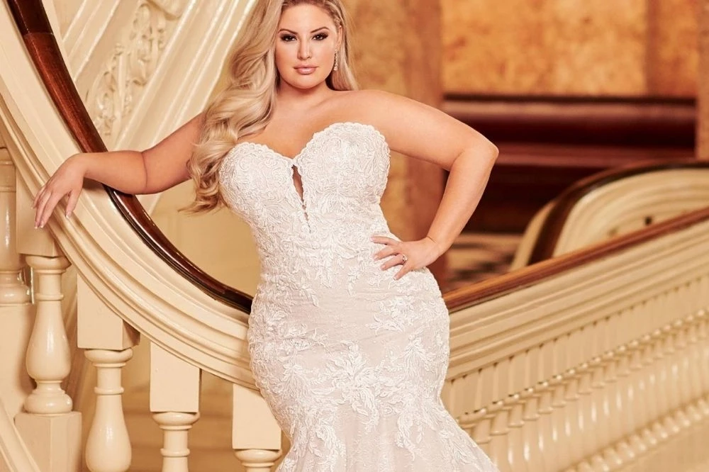 Plus size model wearing a white bridal gown