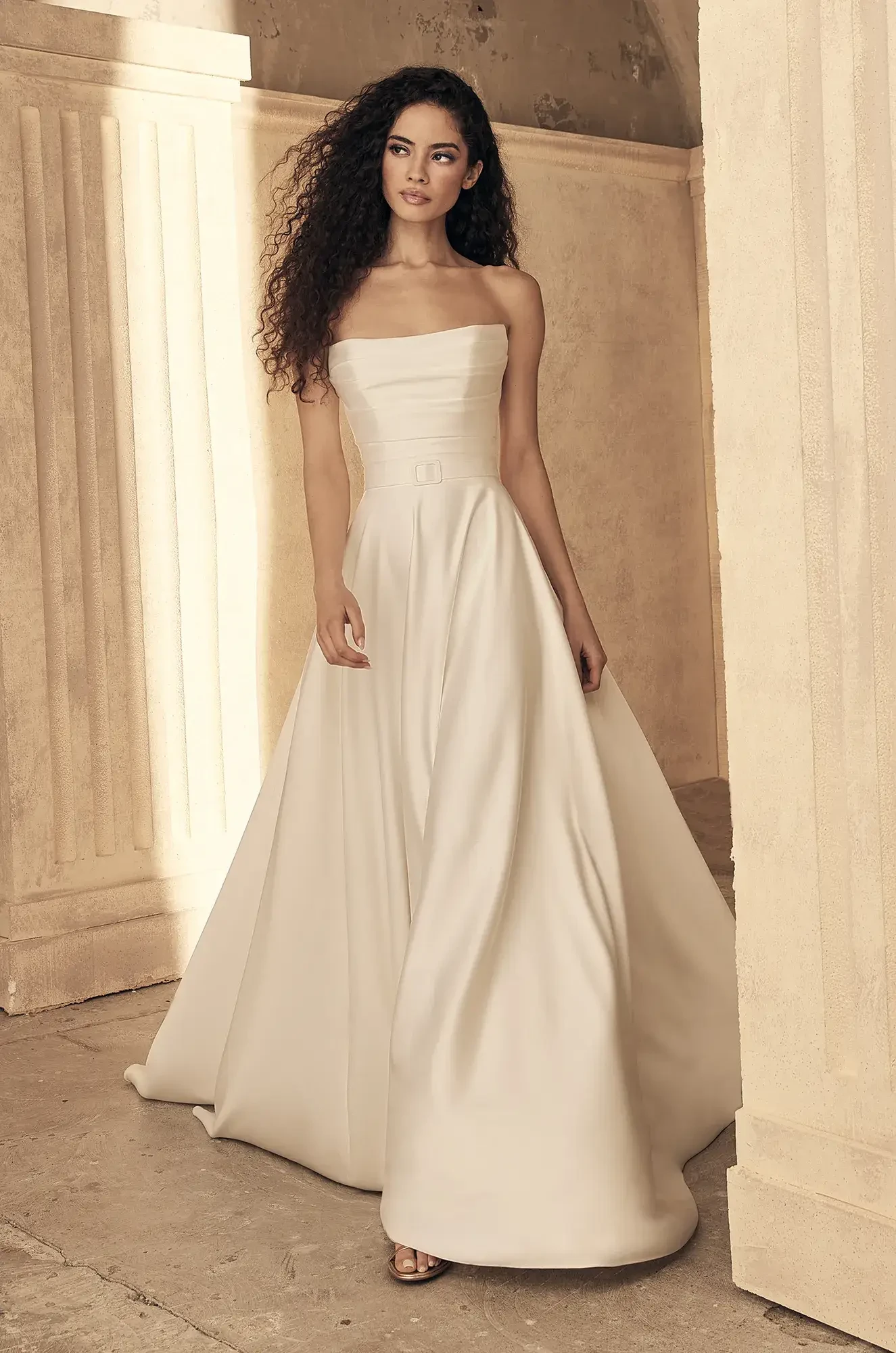 model is wearing a strapless satin a-line wedding gown