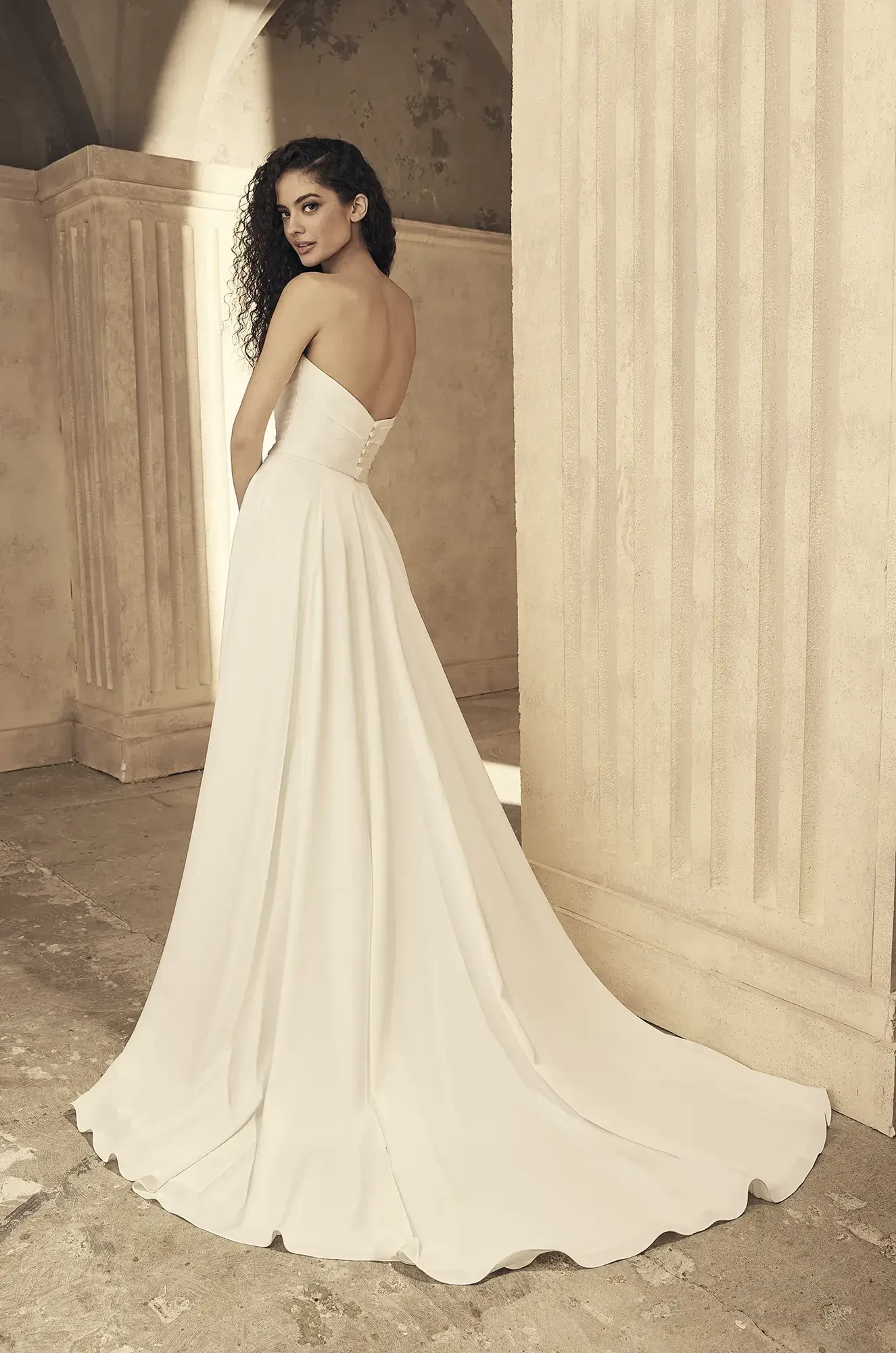 model is wearing a strapless satin a-line wedding gown