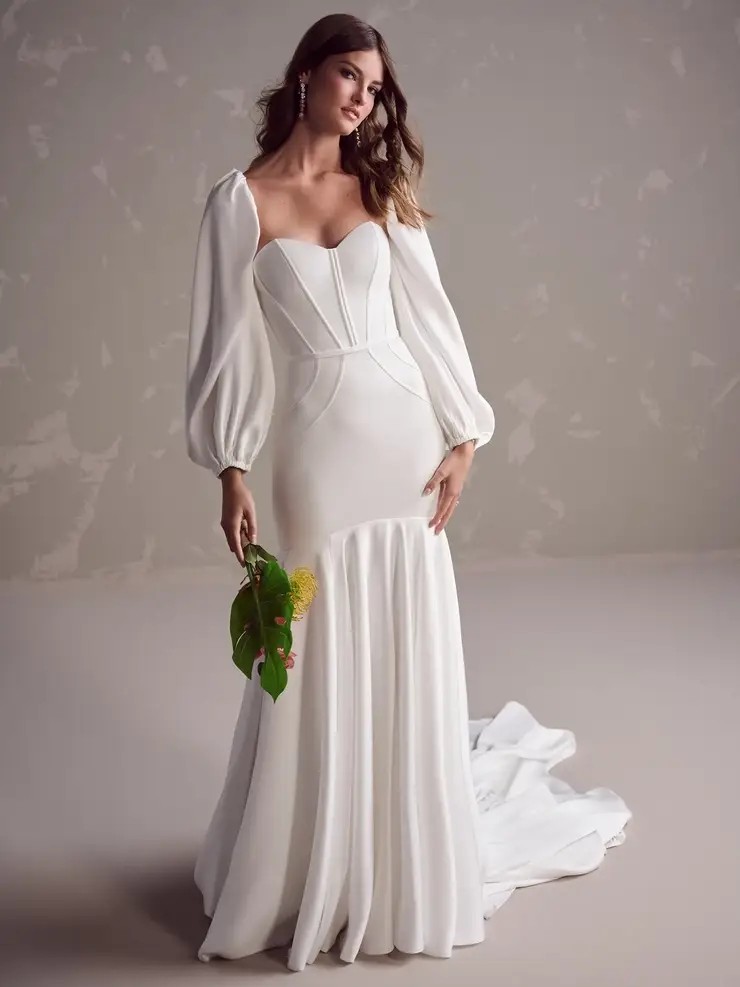 Model is wearing a satin corset mermaid wedding dress with a sweetheart neckline by maggie sottero
