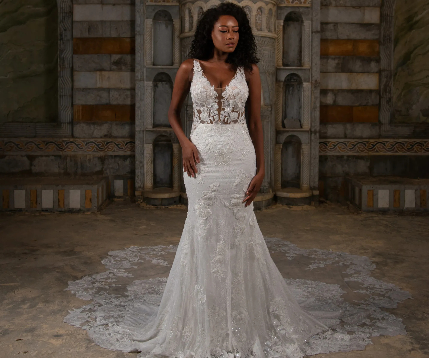Model is wearing a sleeveless fit and flare bridal gown with allover lace by elissar