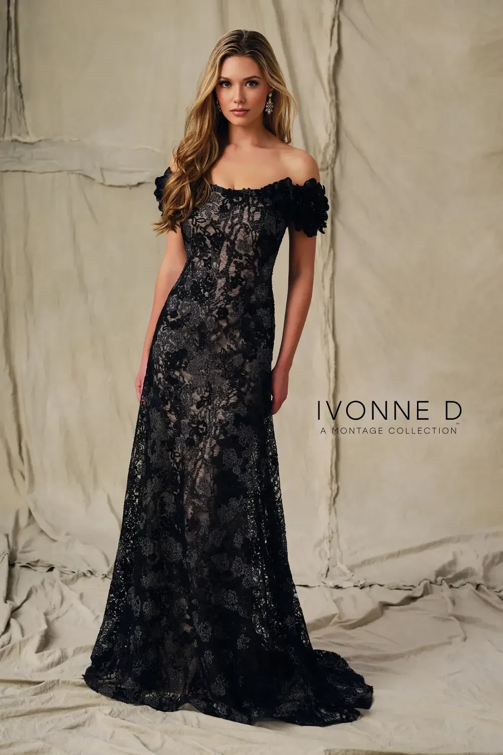 A woman wearing a black lace evening gown with floral details, standing against a neutral backdrop, with the text 