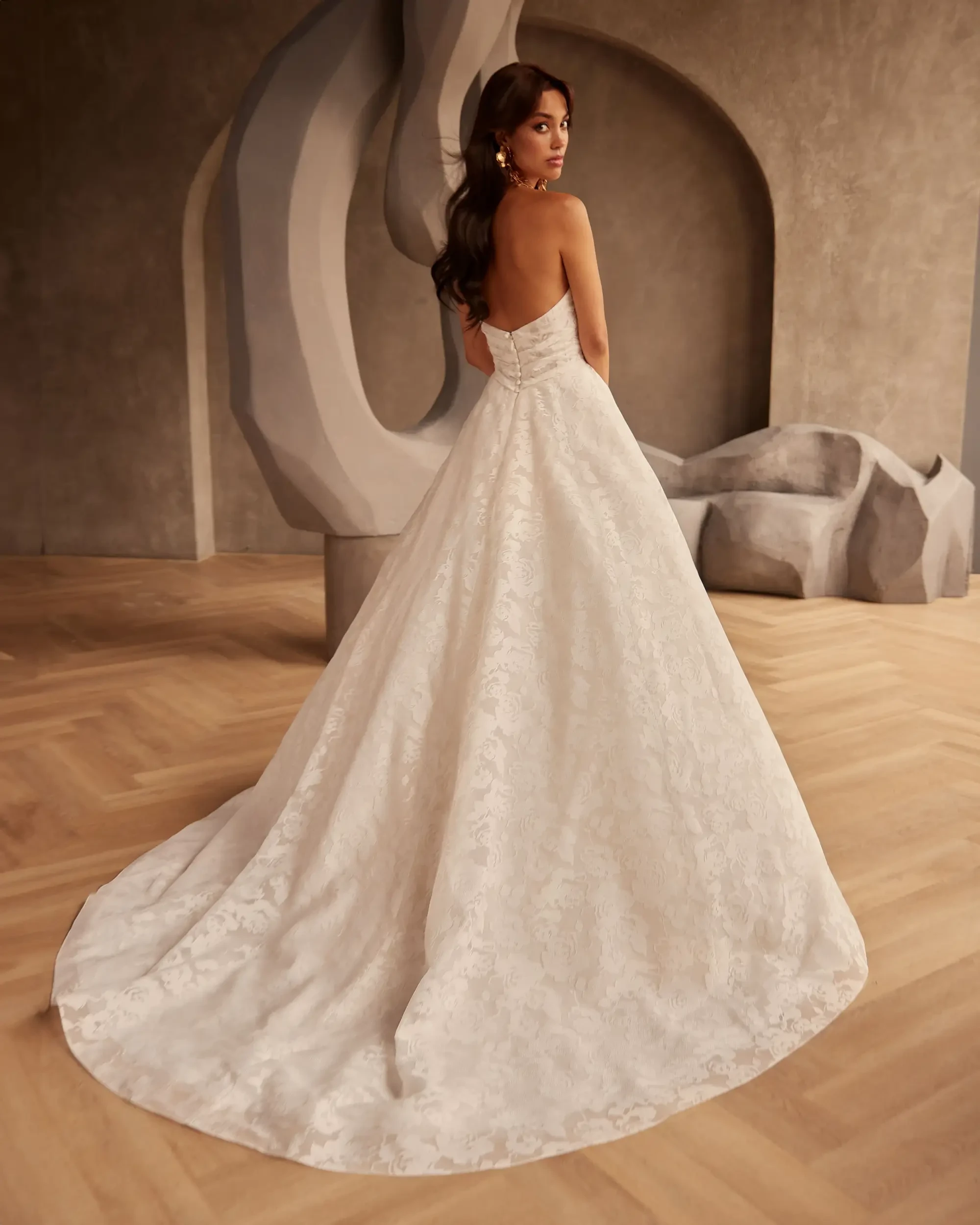 model is wearing a strapless a-line bridal gown with pockets