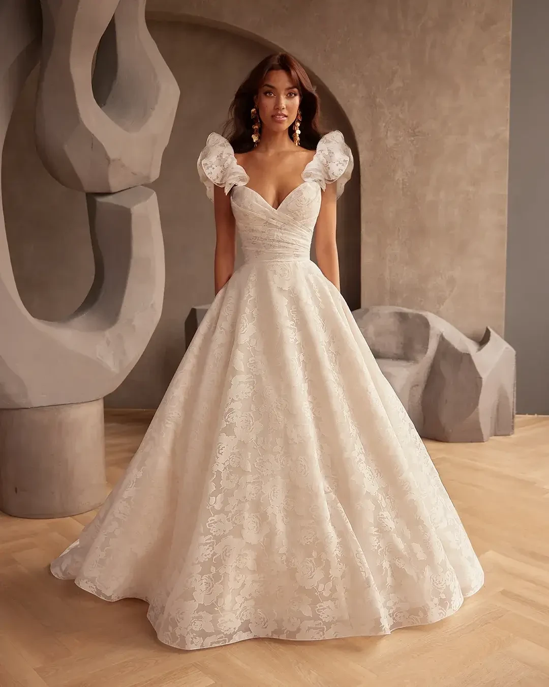 model is wearing a strapless a-line bridal gown with pockets