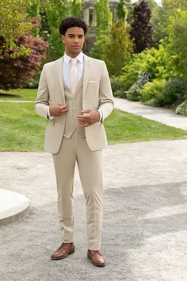 model is wearing a tan suit