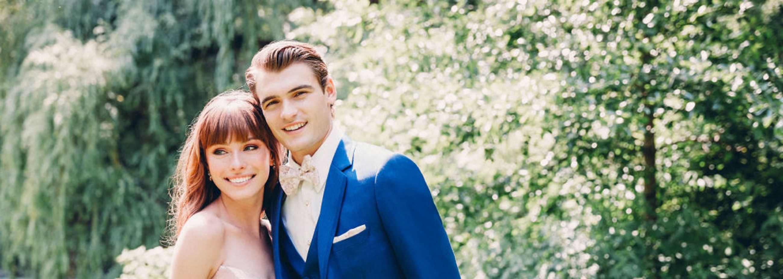 Сouple wearing a white gown and a blue suit