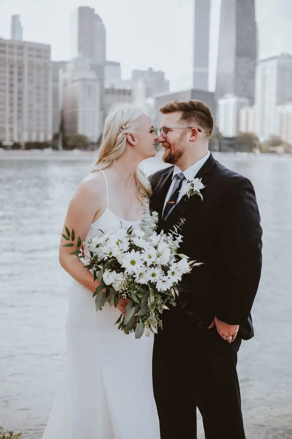 Сouple wearing a white gown and a black suit