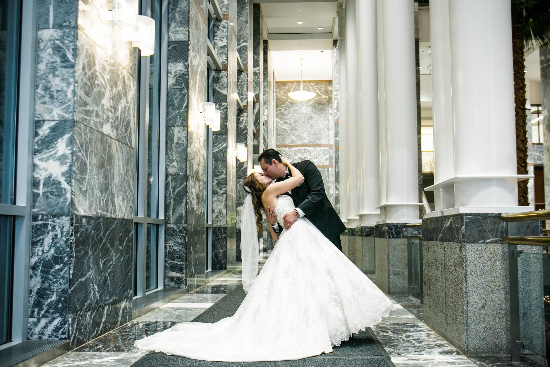 Сouple wearing a white gown and a black suit at hall