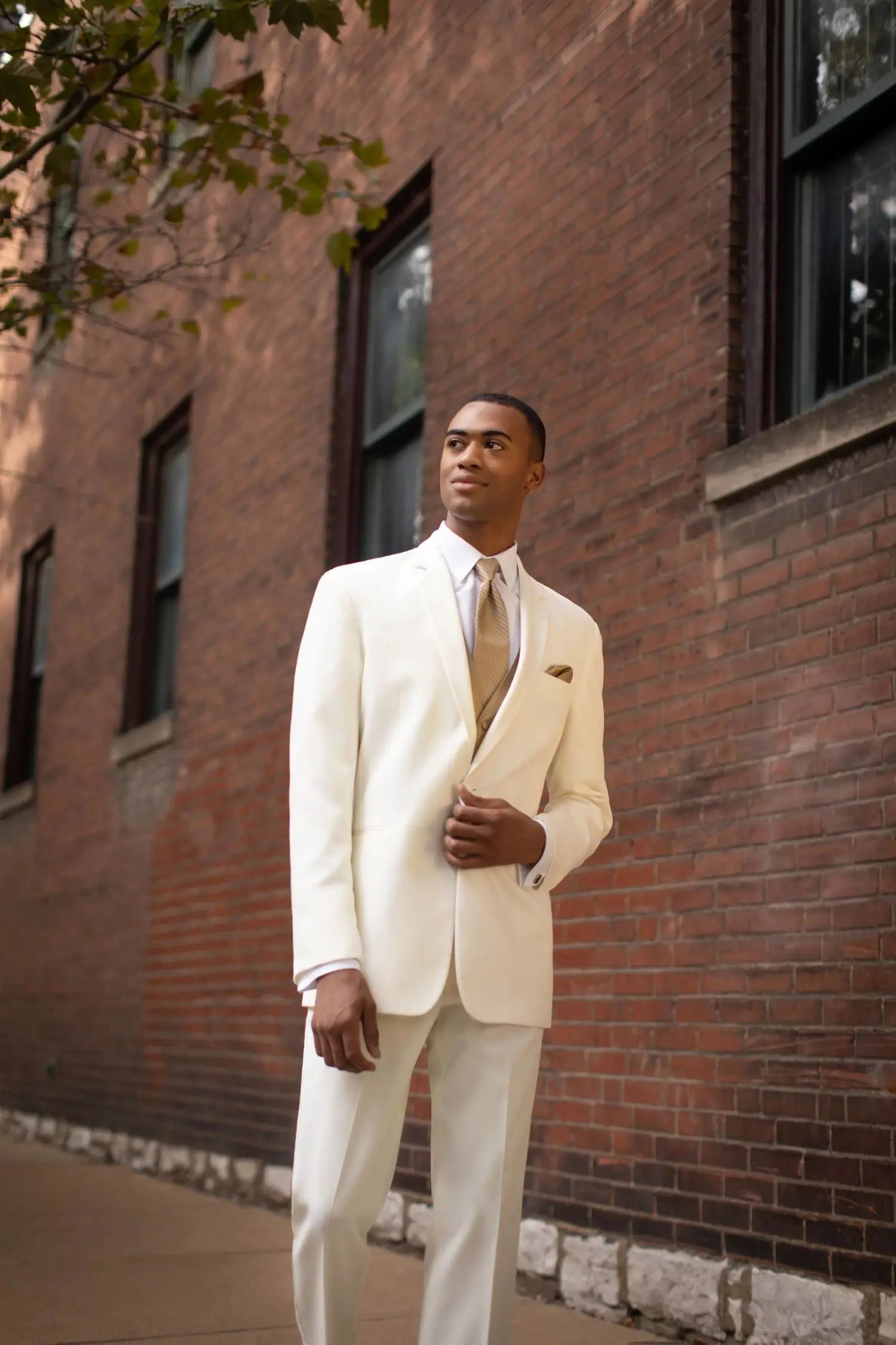 Model wearing ivory tuxedo