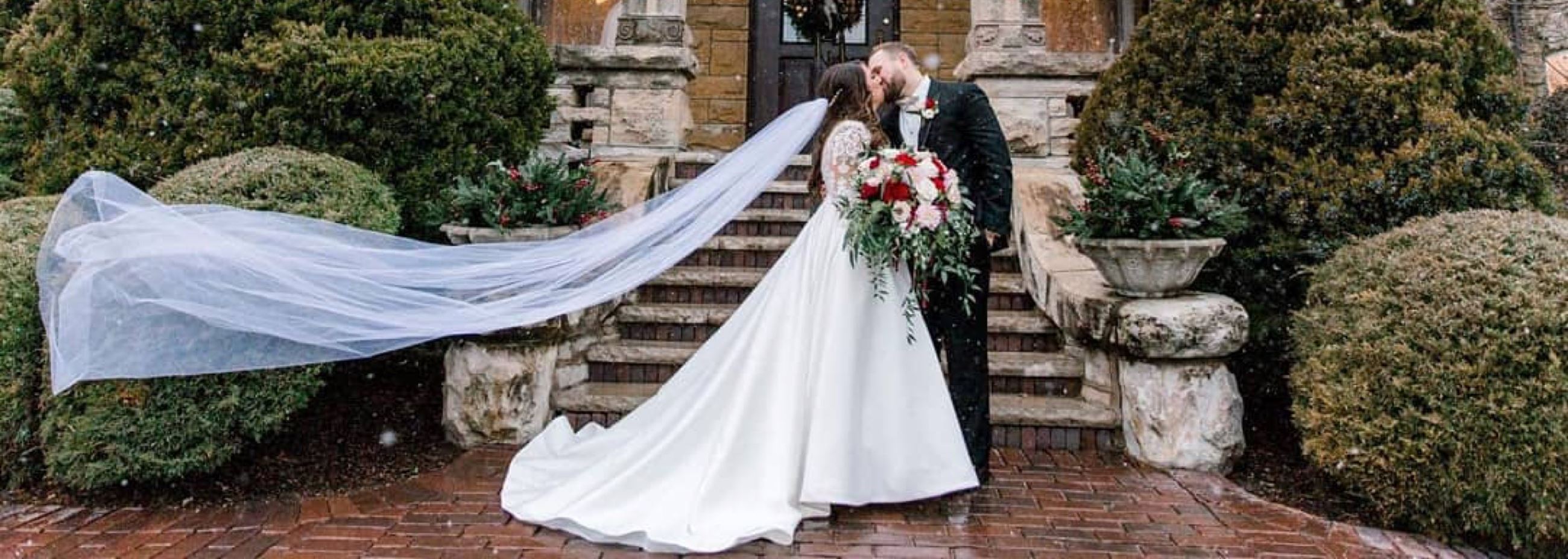 Сouple wearing a white gown and a black suit