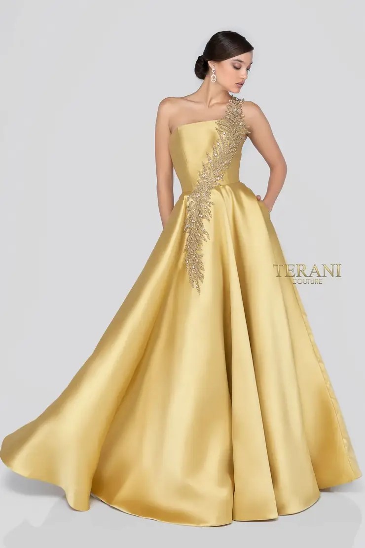 Model wearing a gold Terani mother of the wedding gown
